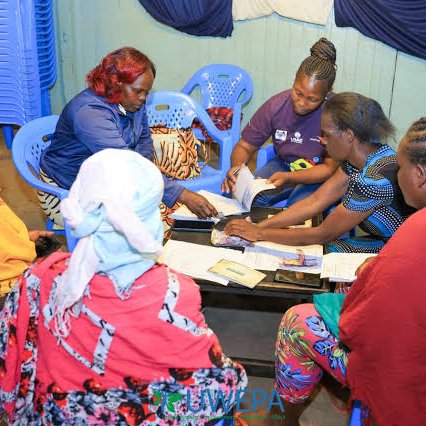 Guardians gather for a table-banking session, building savings together.
